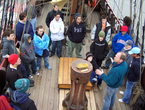Captain Reynolds gathers the entire crew around the capstan for an introductory briefing.