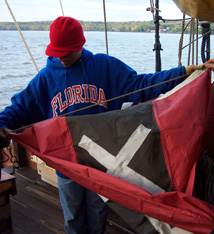 Nate raises the flag of Amsterdam on the mizzen mast.