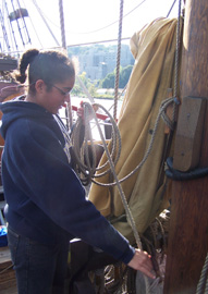 Alex W. coils a buntline on the main mast.