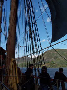 The main mast crew relaxes as the main course arches above them, grabbing the wind.