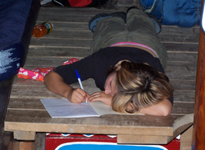Meaghan writes in her journal on the orlop deck.