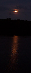The full moon rises over Athens Channel.