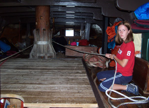 Katie tends the anchor rode as it wraps around the lower capstan.