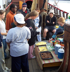Students cluster around the capstan, lining up for breakfast.