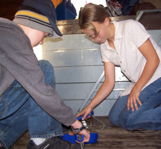 Kyle and Ciara sweep up the orlop deck.