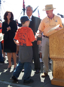 Kyle shakes Captain Reynolds' hand as he receives his certificate of achievement.
