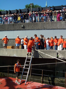 Three tiers of greeters meet our crew as they climb ashore.