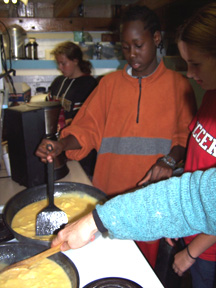 Ericka, Richard, and Katie prepare scrambled eggs in the galley.