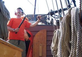 Mr. Terry prepares to fire the swivel gun.