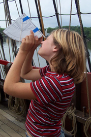 Meaghan uses a quadrant to measure the angle of the sun.