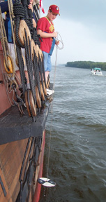 Keith pulls the secchi disk back up after testing the water's turbidity.