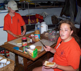 Scenes from the galley: Kathleen and Ericka are caught in discussion as they make sandwiches for lunch.