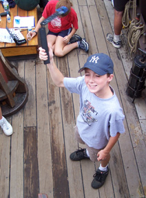 Kyle twirls a sling psychrometer over his head. 