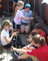 Mrs. Colley oversees Riki, Kathleen, Adam, and Katie as they practice their knots.