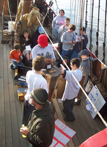 The crew gathers on the weather deck in anticipation of the student presentations.