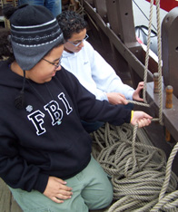 Alex S. and Amro practice belaying lines.