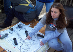Candice points to the ship's current location on a replica 17th century chart of the river.