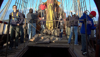 The weather deck is busy as the main mast team works their sails.