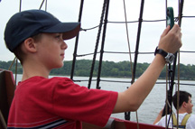 Kyle uses an anemometer to measure wind speed.