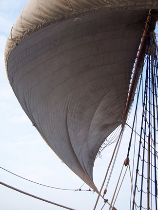 Wind billows the main sail.