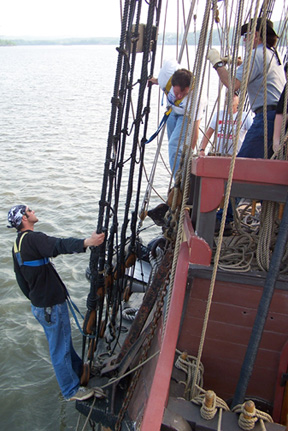 Some of the adult crew prepare to drop the anchor.