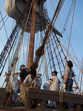 The foredeck crew prepares the fore course.