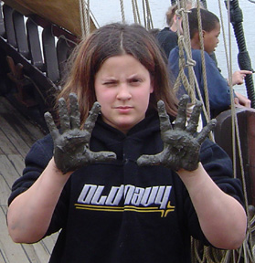 Veronica shows off her mud-caked hands.