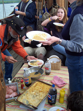 The crew digs in to dinner on the weather deck.