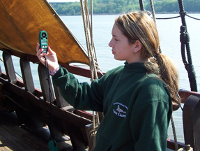 Kiera measures the wind speed on the weather deck.