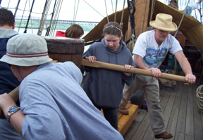 Captain Reynolds joins the students on the capstan bars while raising the anchor.