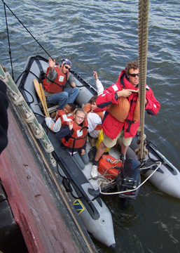 Jamal, Daymien, and Andi wave from the Zodiac.