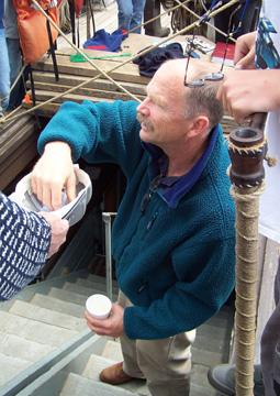 Captain Reynolds draws the winning name out of a hat.