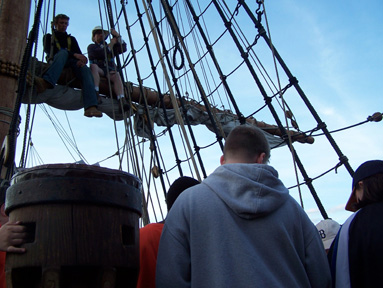 The water team takes a question from Captain Berg and Mr. Weisse, who are sitting on the lowered main yard.