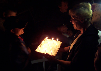 Mrs. Barton presents Veronica with a birthday cake on the orlop deck.