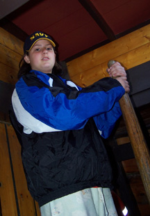 Veronica steers the ship from the helm hutch, both hands firmly gripping the whipstaff.