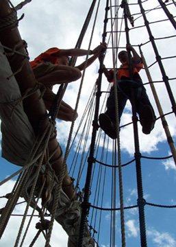 Captain Berg and Jamal climb the rigging.