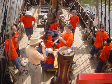 Captain Reynolds casually gathers the crew around the capstan.