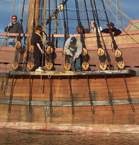 Out on the channel, Daymien takes a sounding while Bryan uses the secchi disk. 