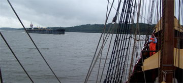 A barge passes the Half Moon on the Hudson River.