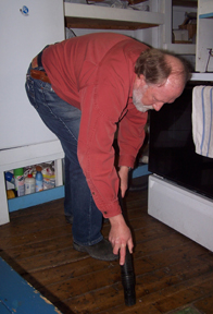 Bob Hansen vacuums the galley.