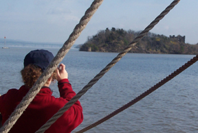 Carole Tice takes a picture of Bannerman's Castle at the mouth of the Highlands.