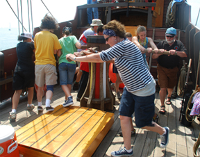 Crew members turn the capstan.