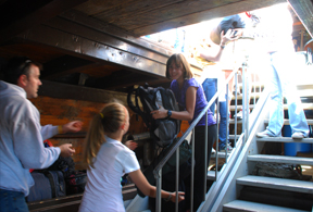 Students relay their gear down to the orlop deck.