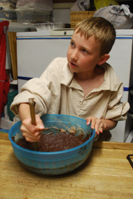 Nick mixes brownies in a large bowl.