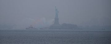 The Statue of Liberty, cloaked in morning fog.