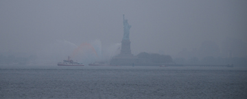 The Statue of Liberty, cloaked in morning fog.