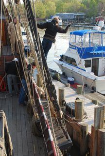 Mr. Moore pulls the slip line to free the Half Moon from its moorings.