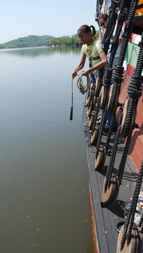 Jasmine takes a sounding with the lead line.