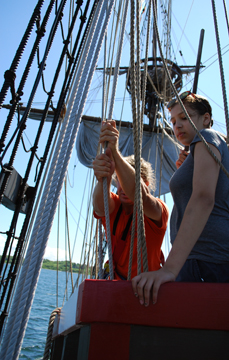 Nadia stands lookout as Mr. Van Grondelle and Jose sweat the anchor tackle.