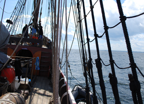 The Half Moon lunges through the crashing surf.